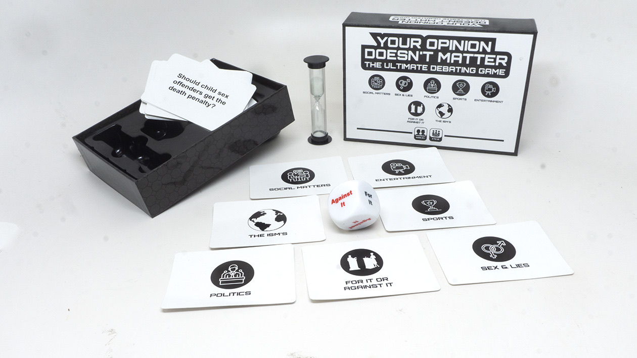 The open YODM box with debate cards, the sand timer, and the die laid out